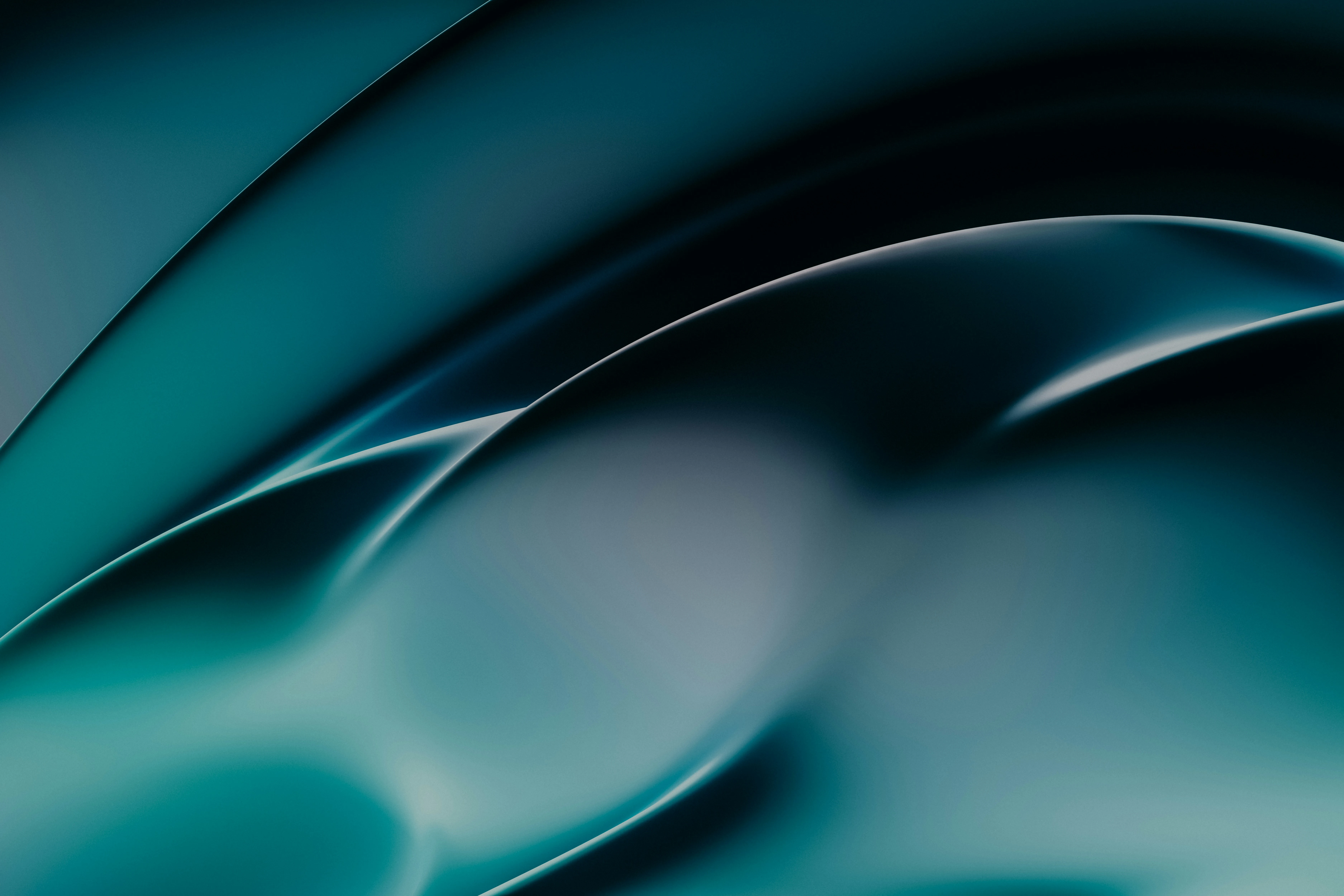 An abstract, curved, teal background. Photo by Pawel Czerwinski on Unsplash.
